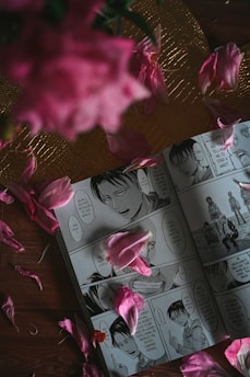 A close-up of colorful manga pages spread out on a table, showcasing intricate artwork.