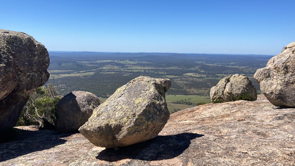 a rock formation on top of a mountain with a view of a valley in the