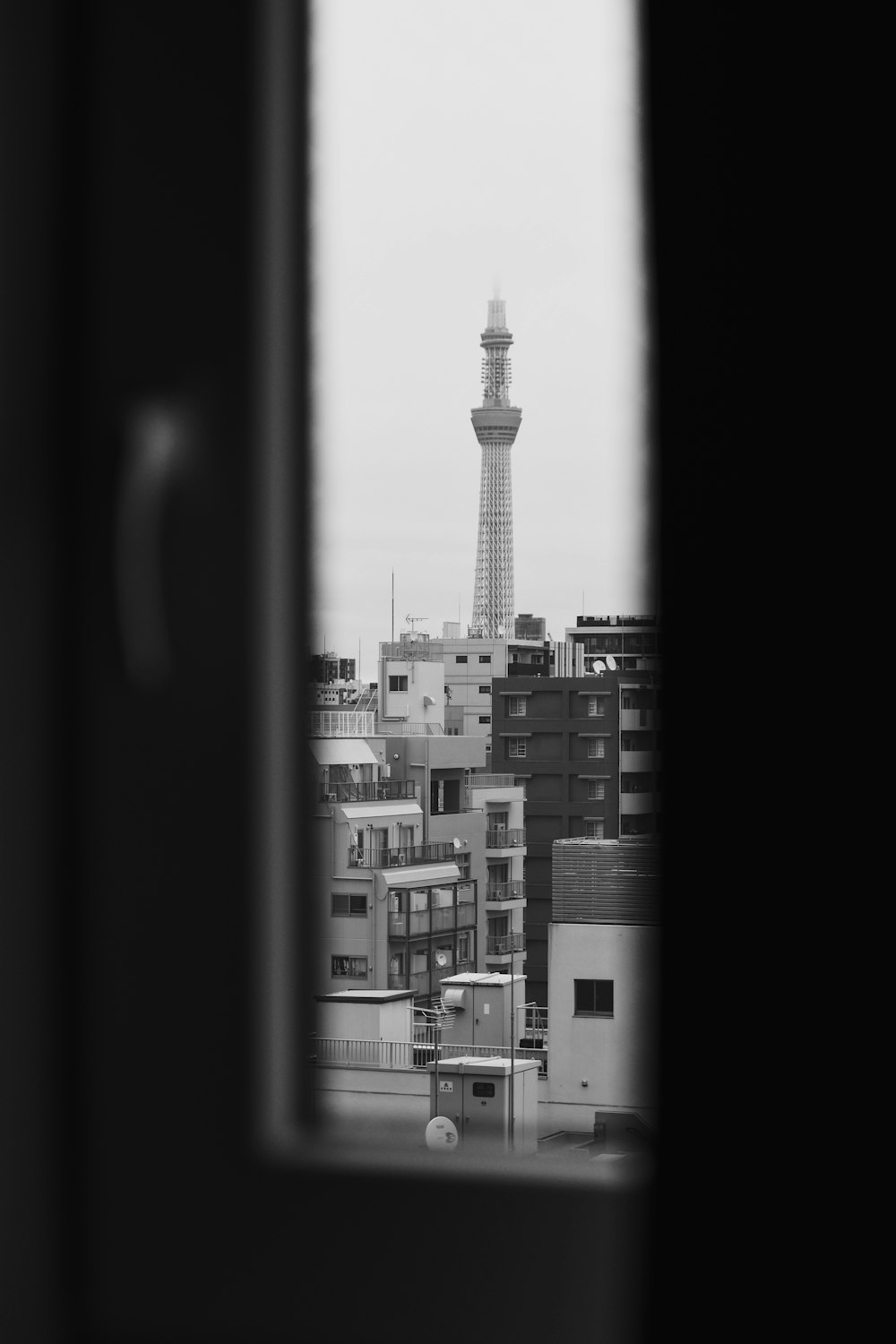 a black and white photo of a tower in the distance
