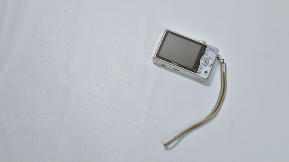 a small electronic device sitting on top of a white surface