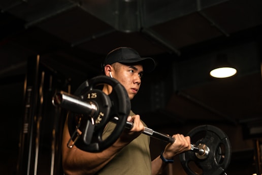 A focused athlete lifting weights in a home gym setting, embodying strength and determination.