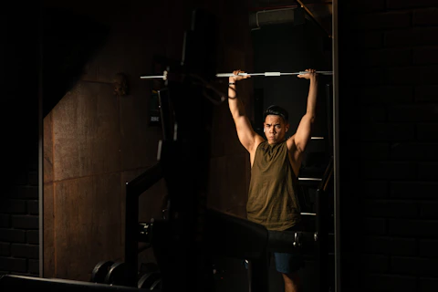 A focused personal trainer guiding a client through a strength training session in a sleek, modern gym.