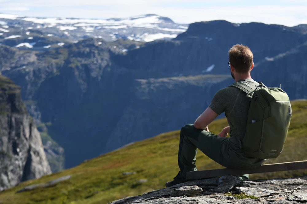 Adventure traveler hiking on mountain trail with safety gear