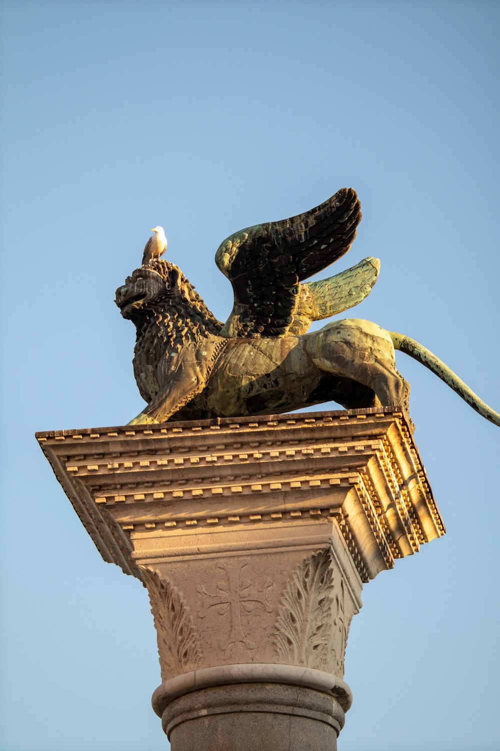 a statue of a bird on top of a building