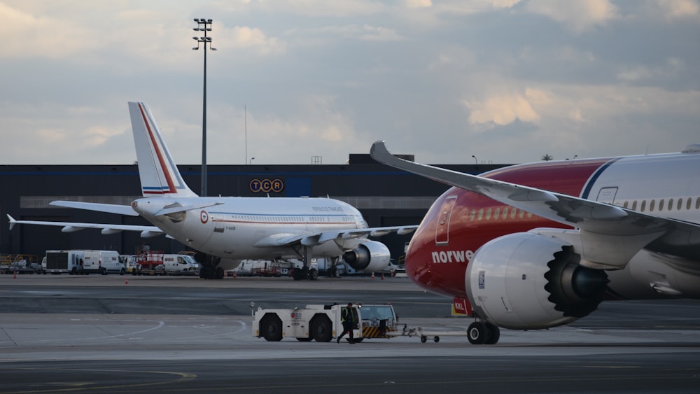 a couple of airplanes that are on a runway