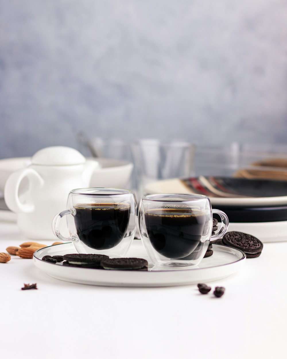 a couple of cups of coffee sitting on top of a plate