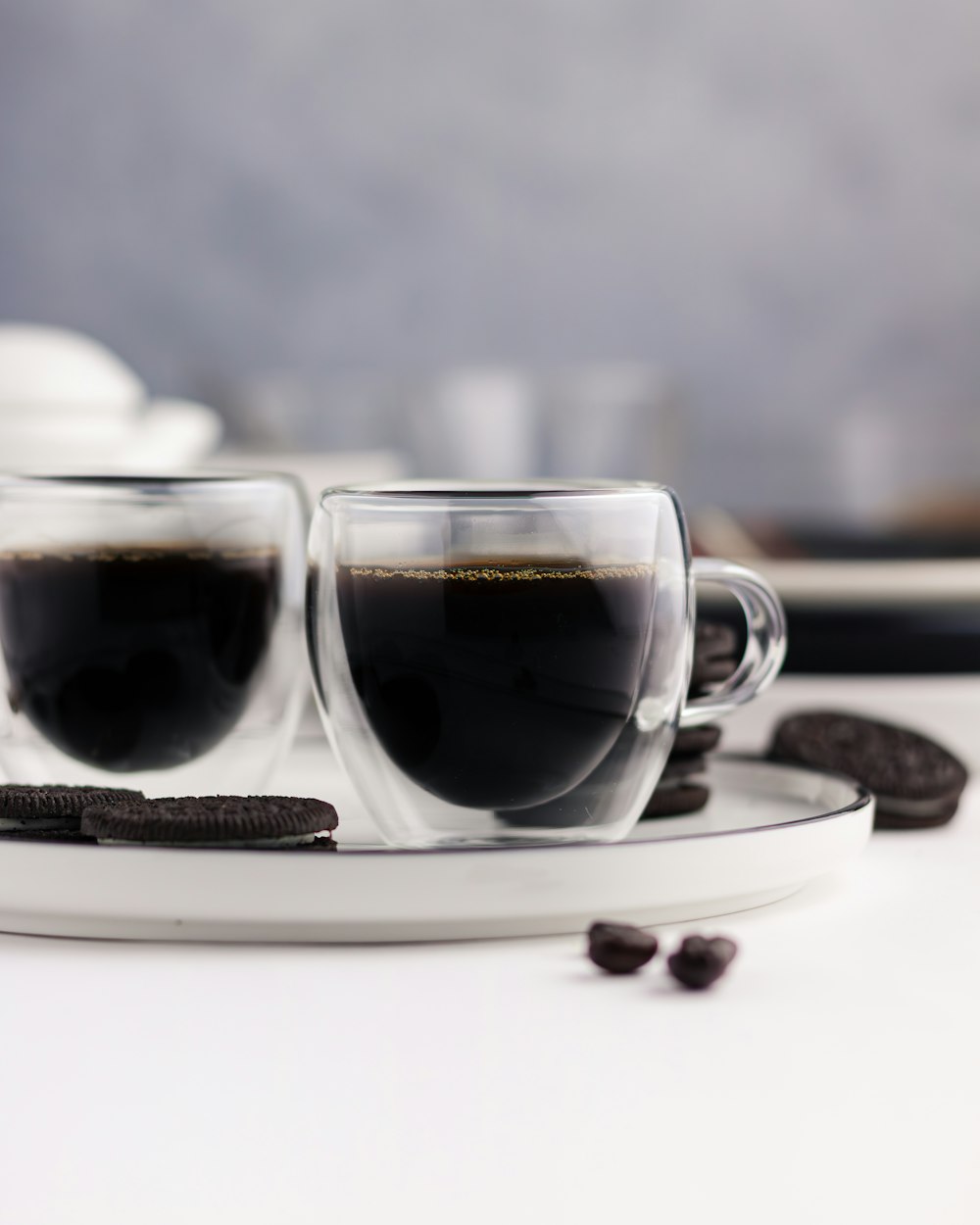 a couple of cups of coffee sitting on top of a plate