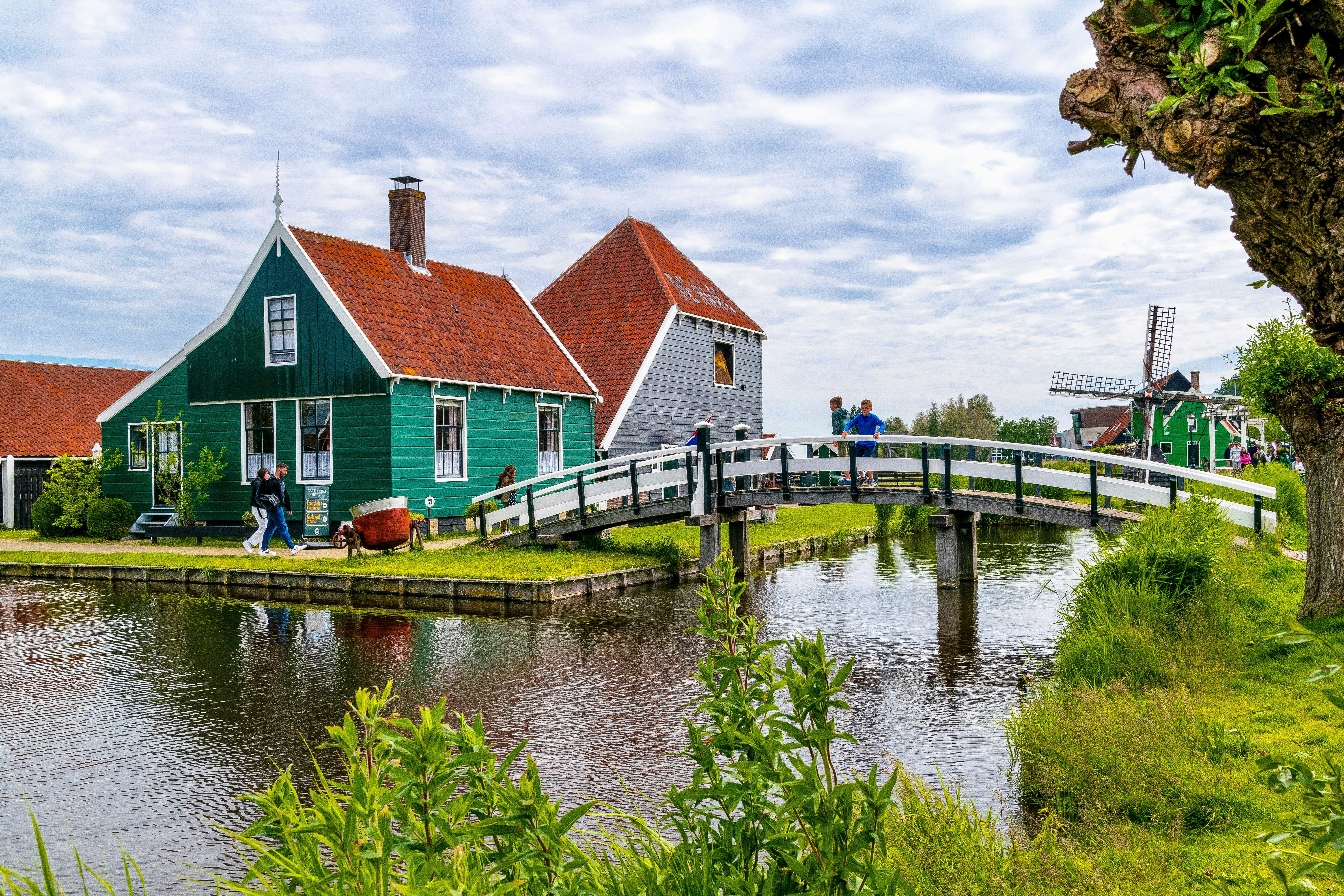a couple of houses sitting next to a river