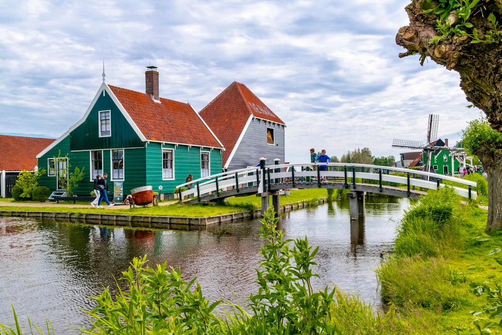 a couple of houses sitting next to a river