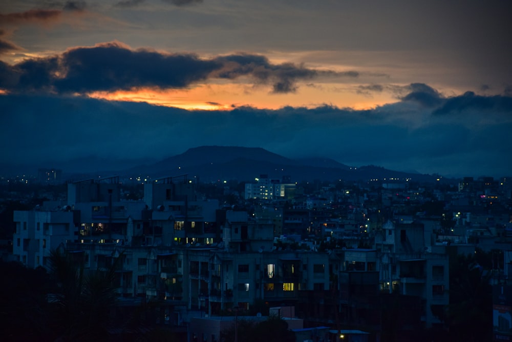 a view of a city at night with a mountain in the background