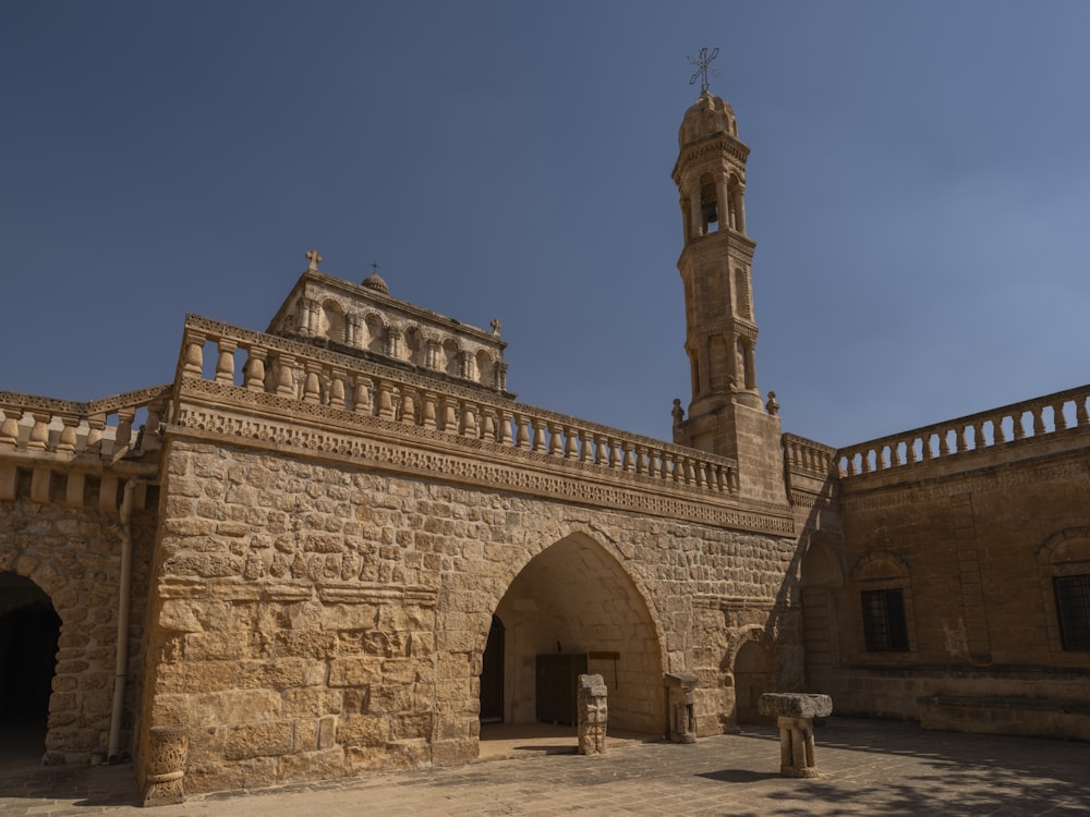 a stone building with a clock tower in the background