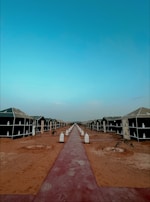 Pathway lined with lanterns leading to the cozy glamping tents at dusk.
