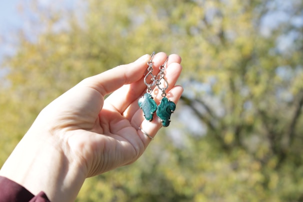 A model showcasing oxidized earrings in a natural outdoor setting.