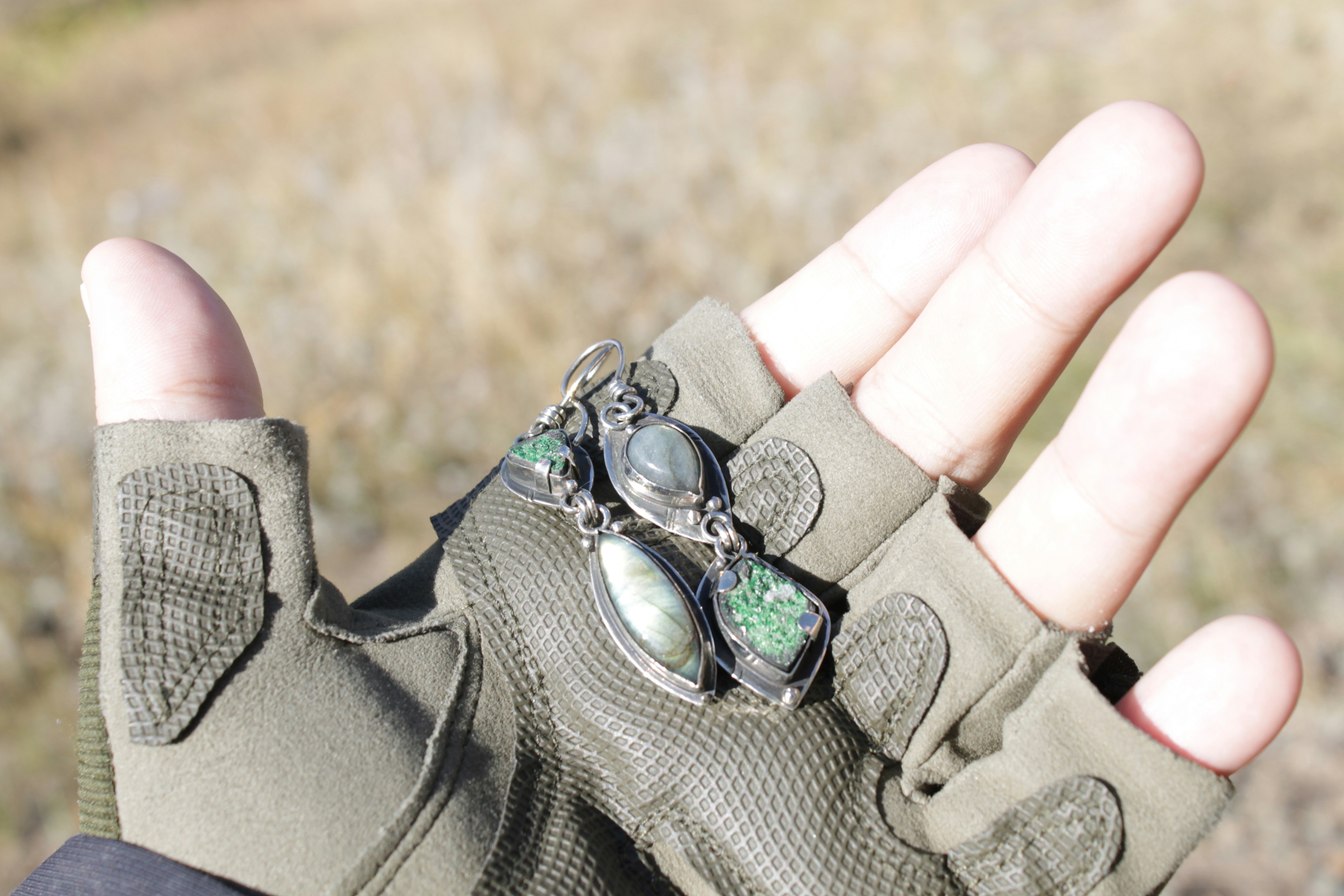 Hand holding archery eye protection goggles.