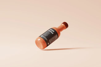 A sleek bottle of seh multi-functional liquid food enhancer next to fresh ingredients on a clean kitchen counter.