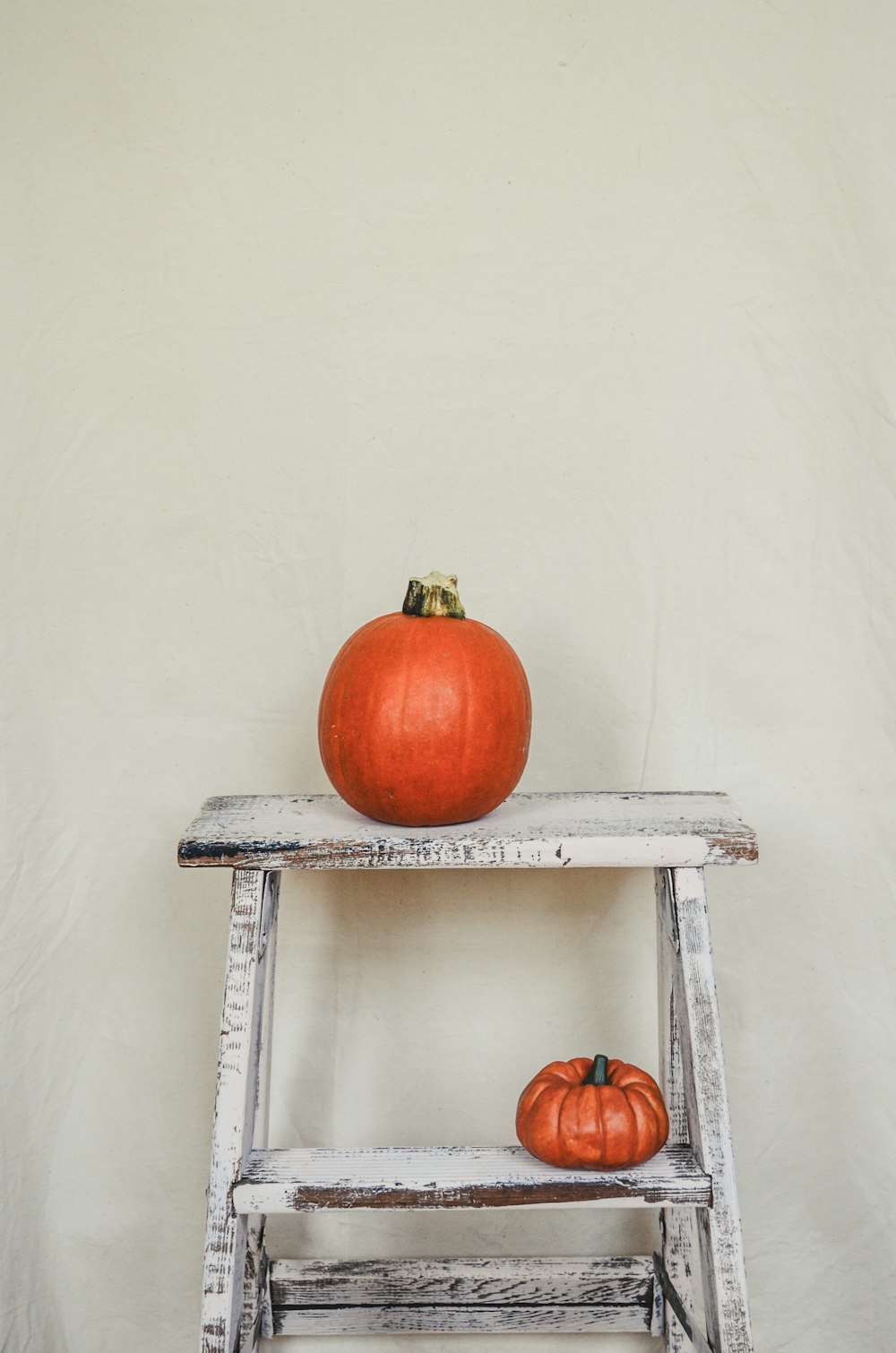 a pumpkin sitting on top of a wooden shelf