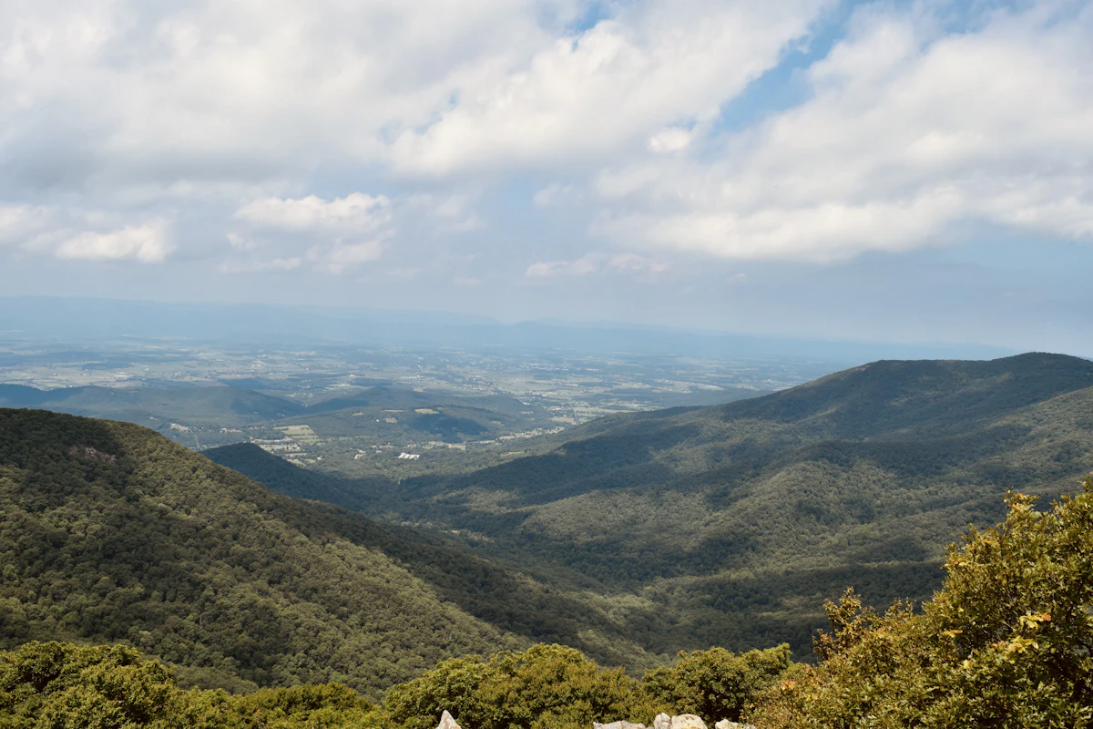 Green forested ridges above a wide valley, seen from Shenandoah National Park east of the race