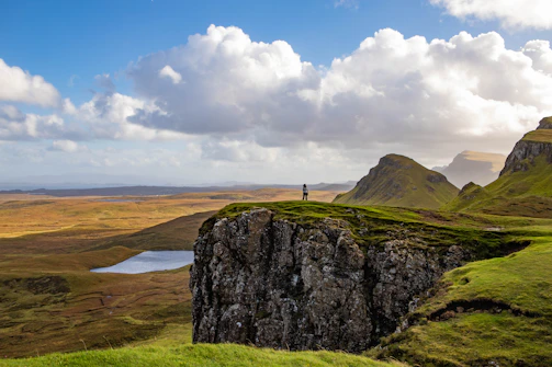 a person standing on top of a cliff