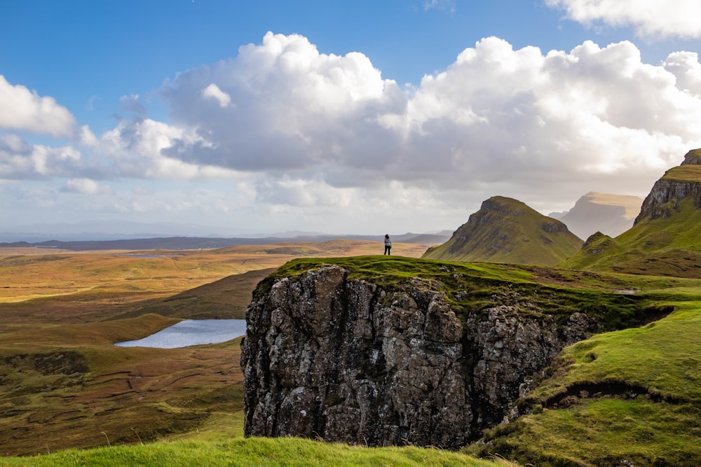 a person standing on top of a cliff