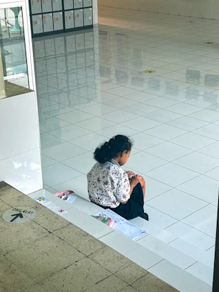 A thoughtful researcher analyzing government policy documents in a bright modern study room.