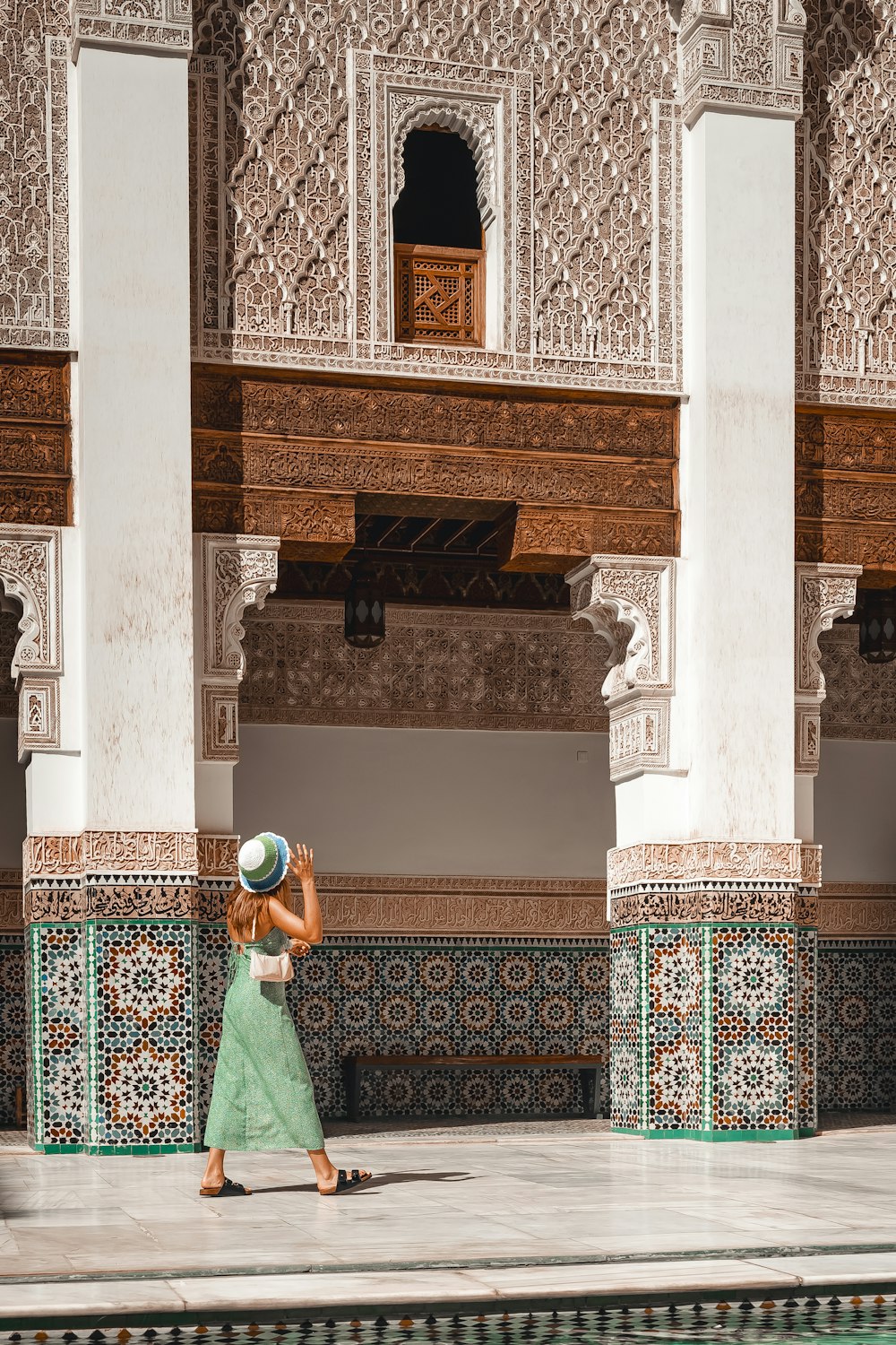 a woman in a green dress and a hat