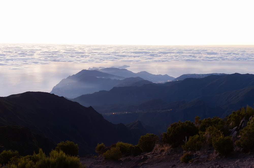 a view of a mountain range with low lying clouds