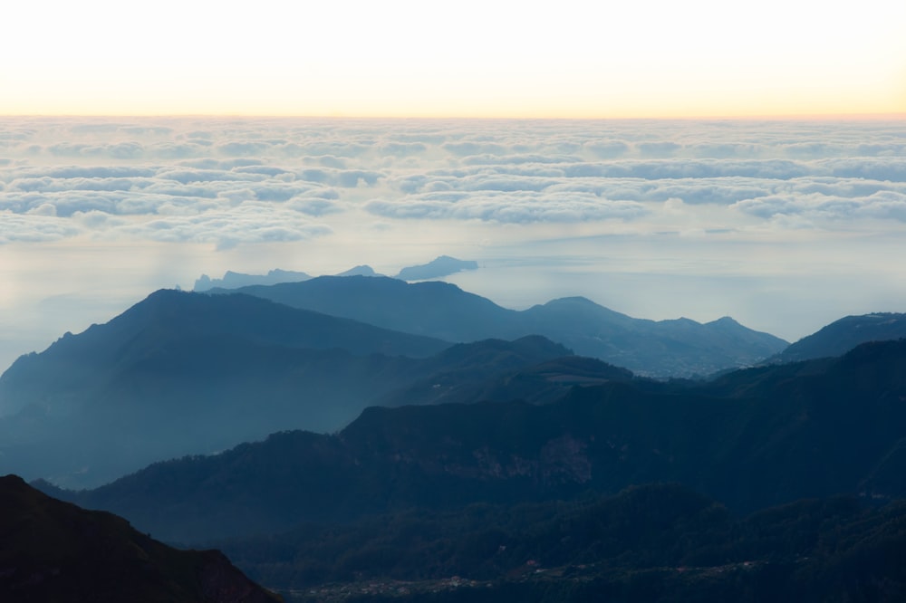 a view of a mountain range covered in clouds