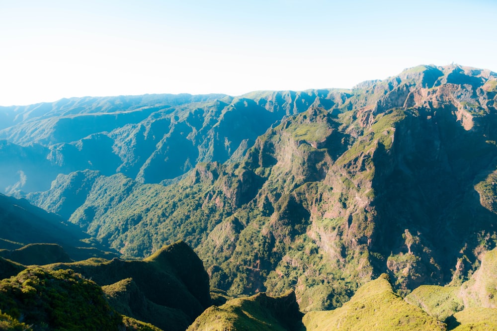 a view of a mountain range from the top of a hill