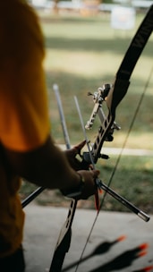 a person holding a bow and arrows in their hands
