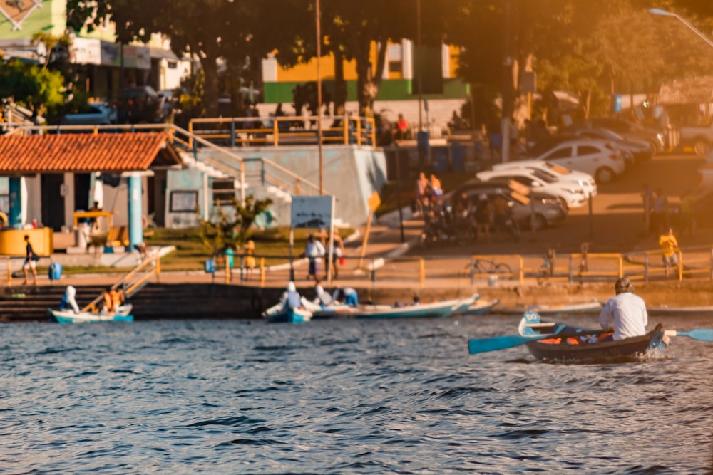 a man in a small boat on a body of water