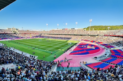 A packed stadium with scouts watching a youth soccer showcase.