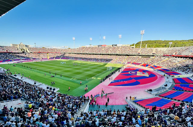 A lively outdoor soccer match with players and spectators enjoying colorful Caribbean festival decorations.