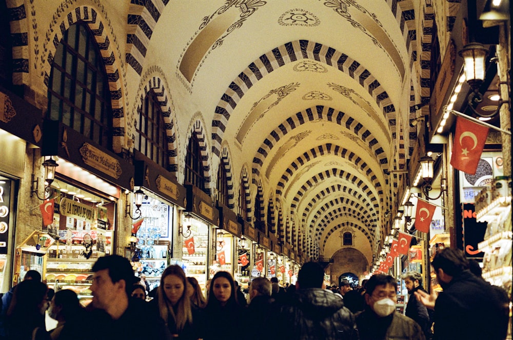 a group of people walking through a shopping mall