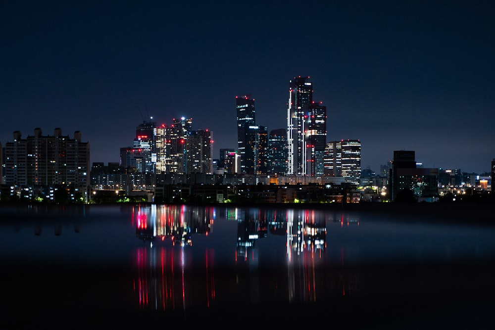 a city skyline is lit up at night