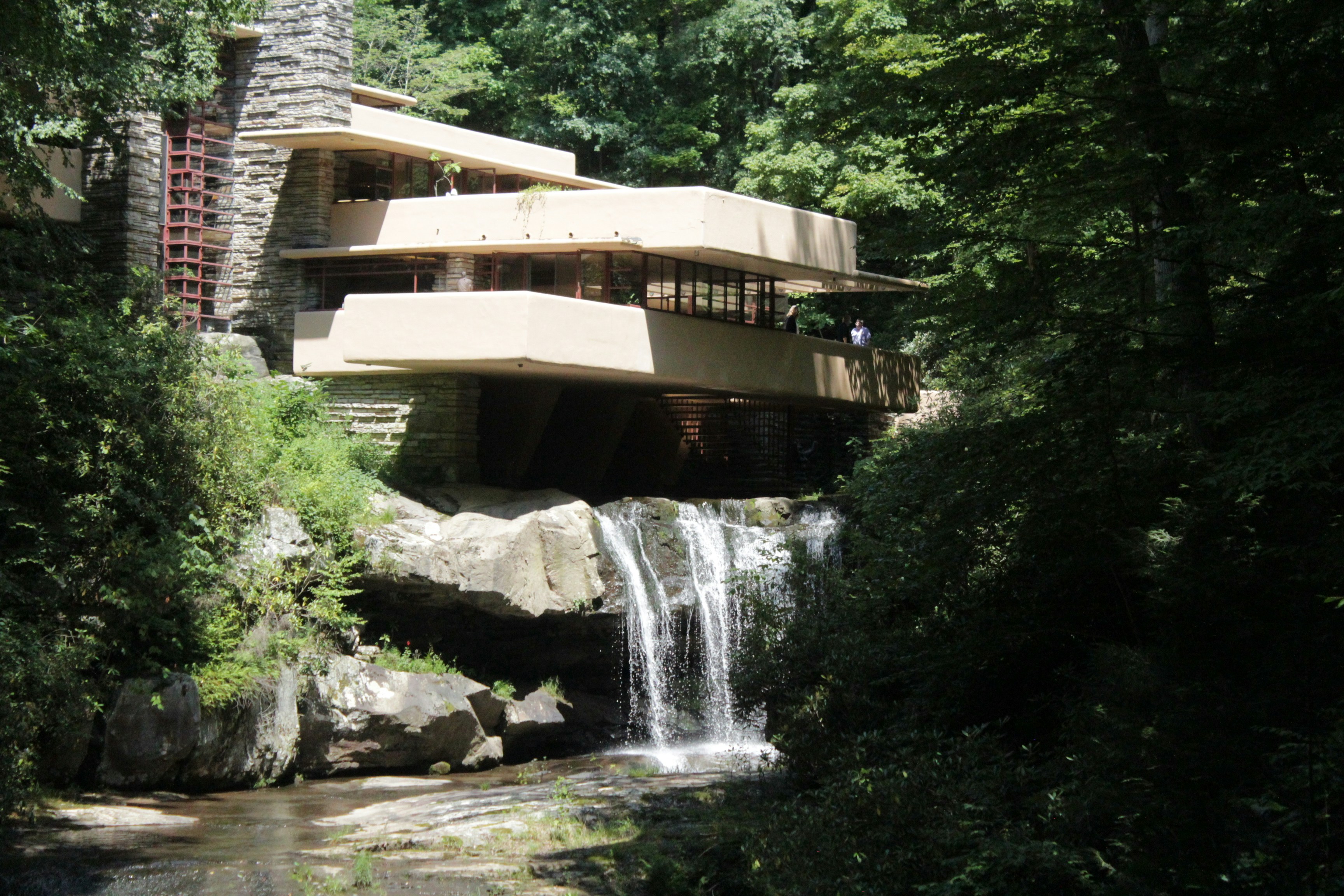 a house with a waterfall in front of it