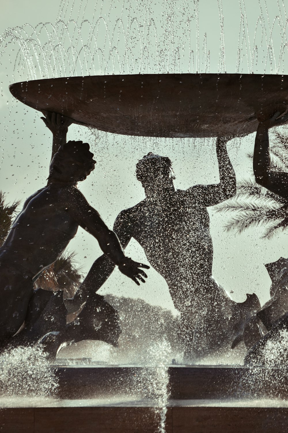 a group of people playing in a fountain