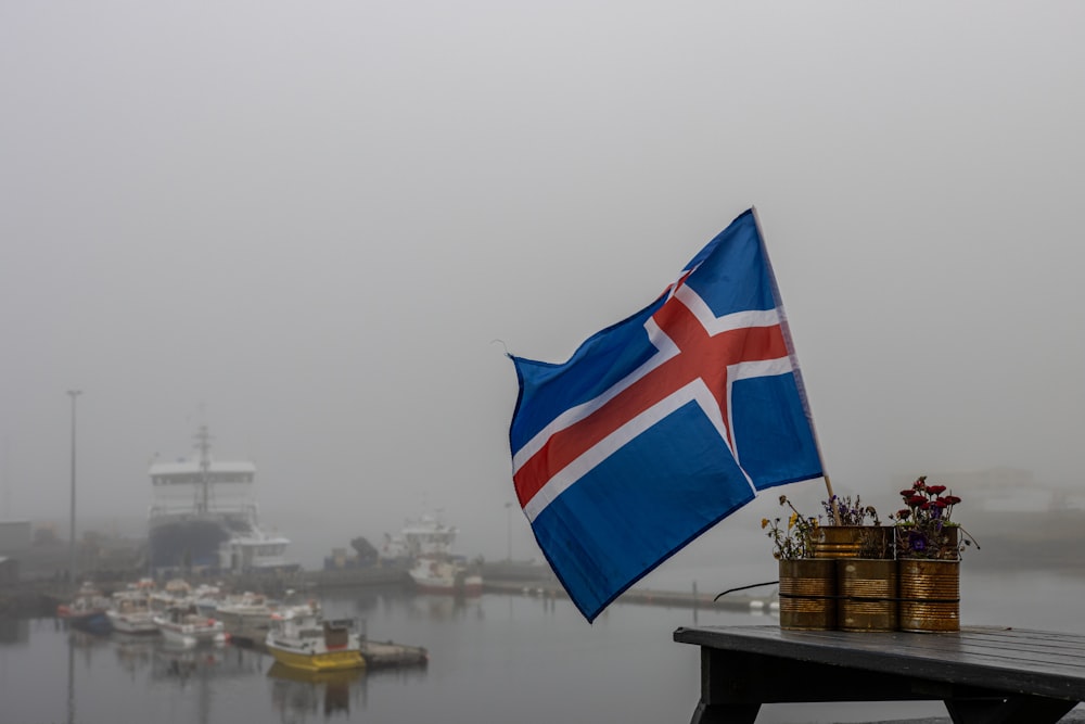 a flag flying over a body of water