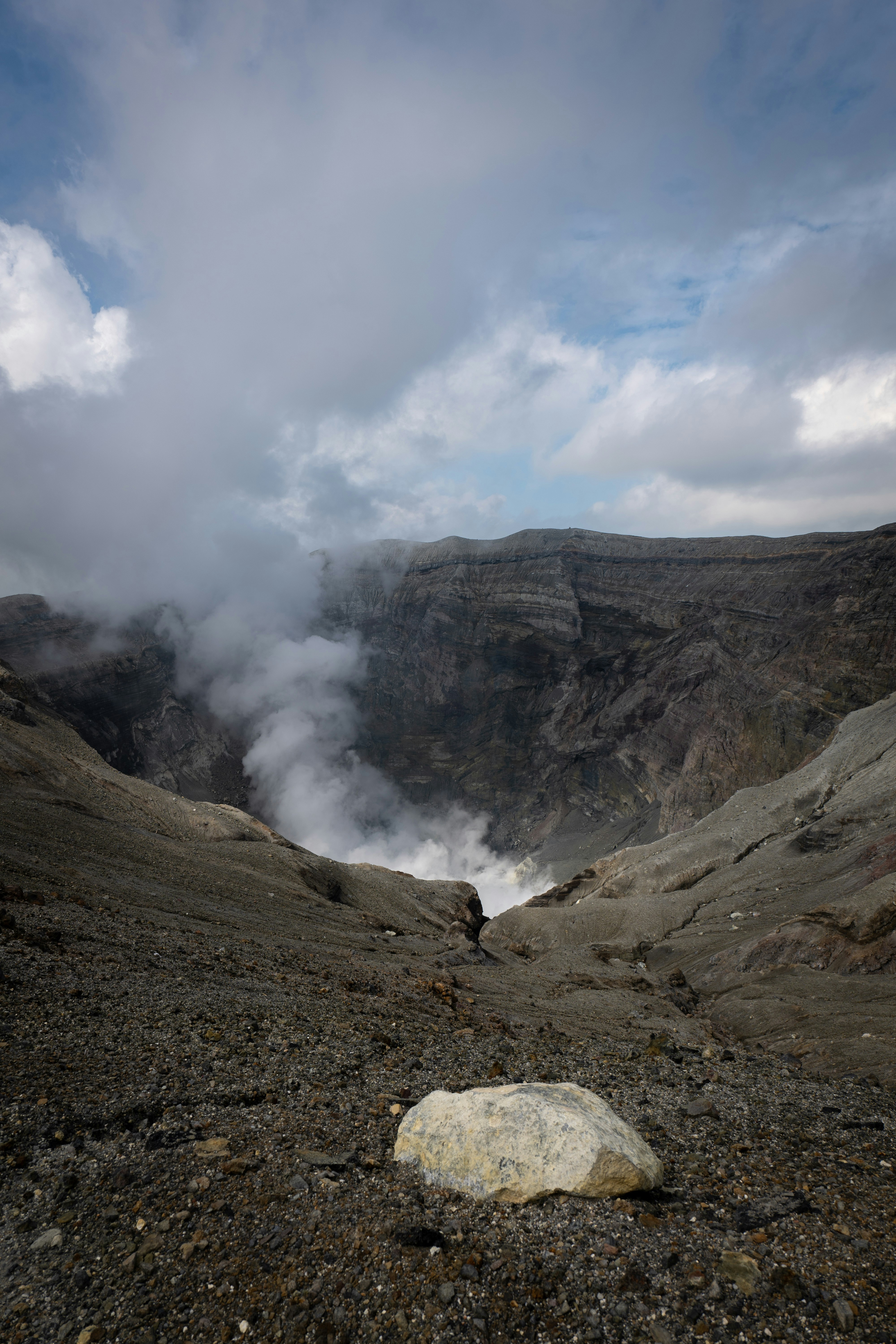 a large rock sitting on top of a rocky hillside
