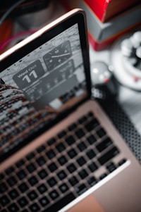 A close-up of a stopwatch overlaying a fast-loading website on a laptop screen.