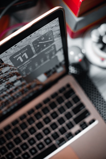 A close-up of a stopwatch overlaying a fast-loading website on a laptop screen.