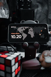 A clock showing 24 hours with a WhatsApp icon and Tokopedia logo in the background.