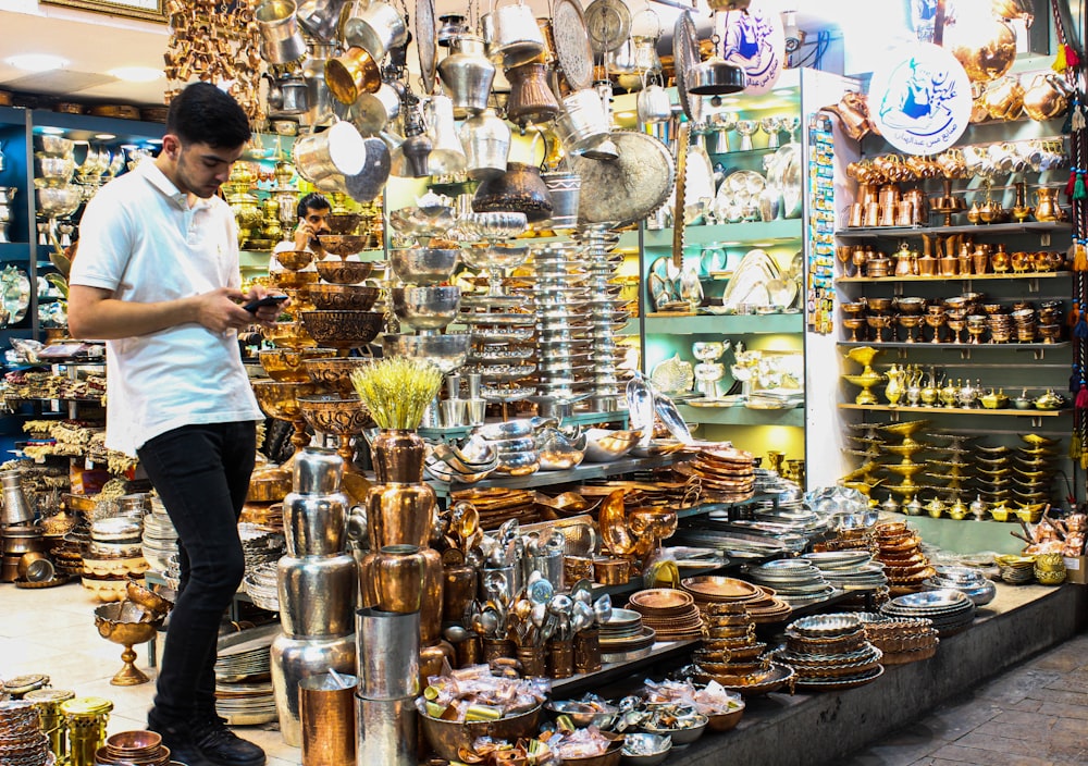 a man looking at his cell phone in a store