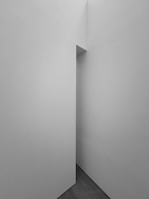 A minimalistic architectural space with clean lines and sharp angles, exhibiting a sense of depth and simplicity.