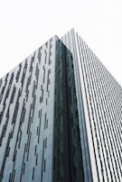 A sleek office tower rising amidst a bustling cityscape, reflecting Gündogan Yapi’s superstructure expertise.