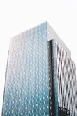 Sleek commercial building in a bustling Indian city with reflective glass and navy blue accents.