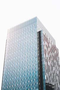 Elegant modern office building with dark blue and copper accents reflecting the Shiohara brand colors.