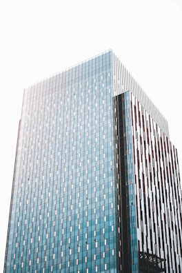 Sleek commercial building in a bustling Indian city with reflective glass and navy blue accents.