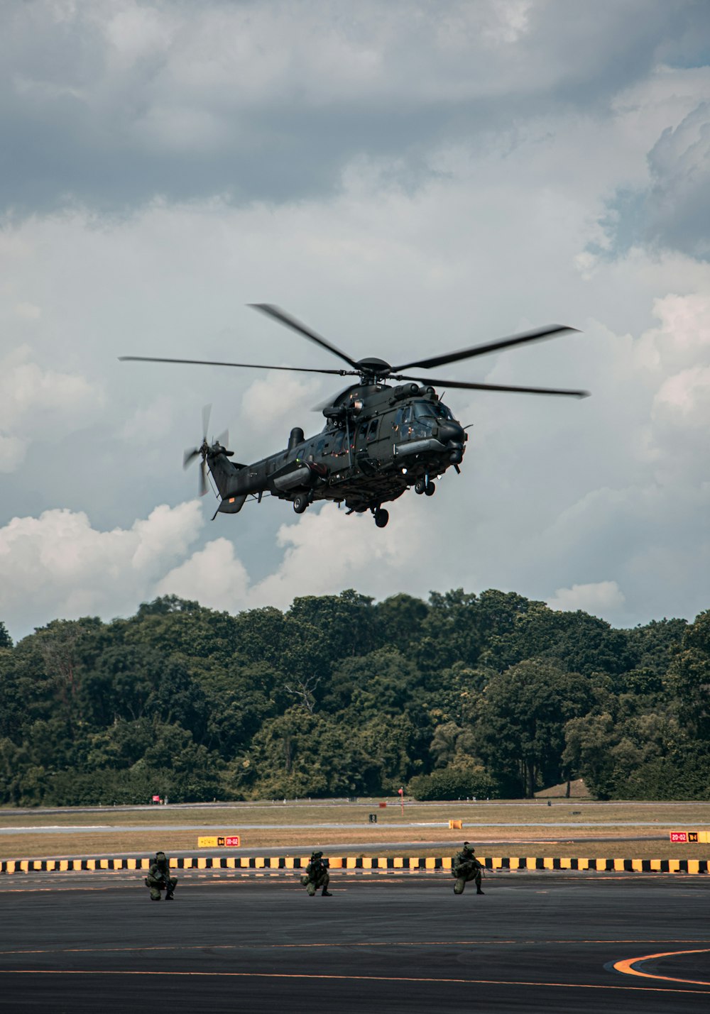 a helicopter is flying low over a runway