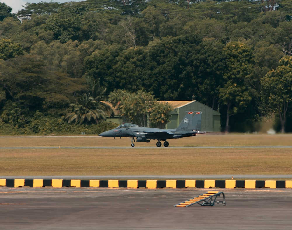 a fighter jet taking off from an airport runway