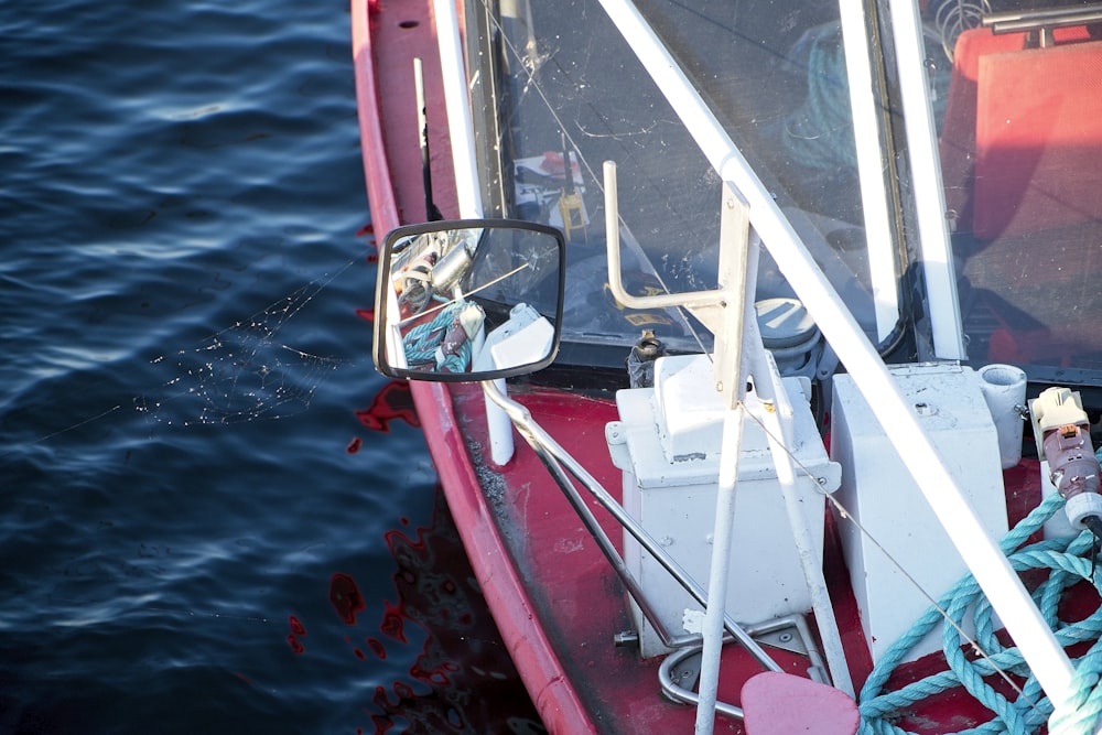 a red and white boat in the water